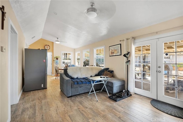 living room featuring french doors, wood finished floors, a ceiling fan, and vaulted ceiling