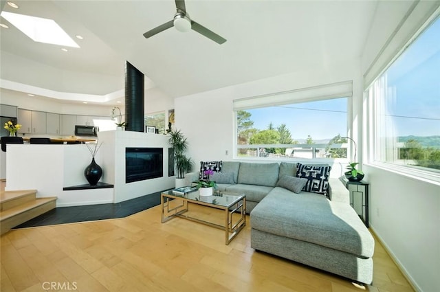 living room featuring a wealth of natural light, recessed lighting, baseboards, and wood finished floors