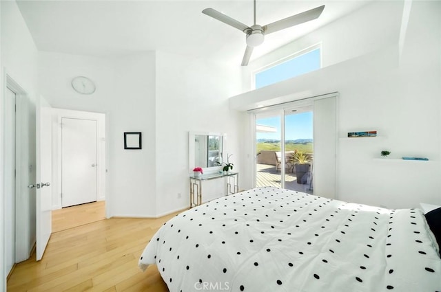 1735 Spencer St, Cambria, CA 93428 - bedroom featuring access to exterior, light wood-style floors, a towering ceiling, and ceiling fan