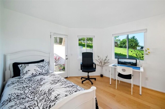 bedroom with baseboards and light wood-type flooring