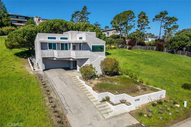1735 Spencer St, Cambria, CA 93428 - contemporary house with stucco siding, a garage, and asphalt driveway