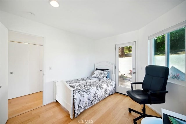 bedroom with recessed lighting, baseboards, light wood-style flooring, and access to exterior