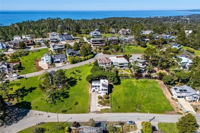 birds eye view of property with a water view and a residential view