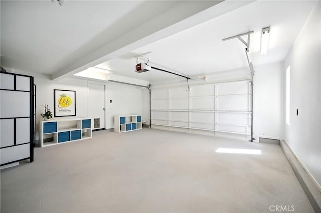 garage with a garage door opener and baseboards