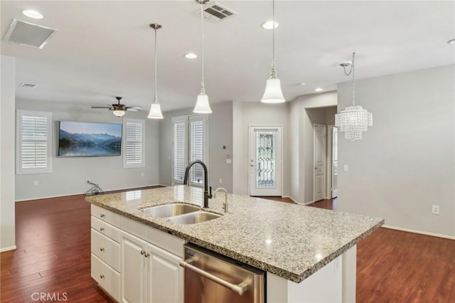 kitchen with dishwasher, dark wood-style floors, visible vents, and a sink