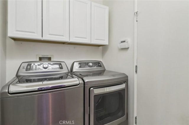 laundry area featuring washer and dryer and cabinet space