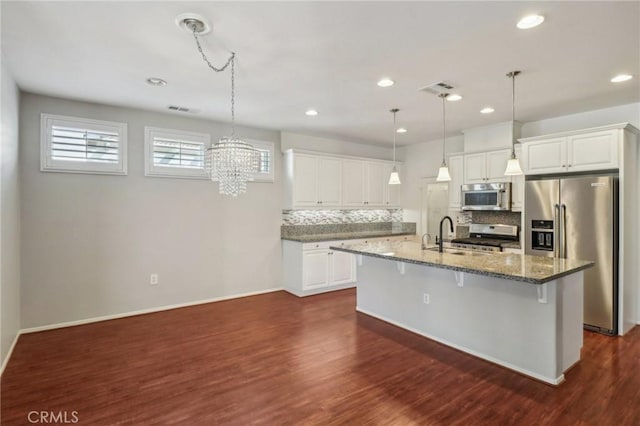 kitchen featuring a sink, stainless steel appliances, decorative backsplash, and dark wood-style flooring