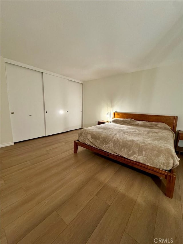 unfurnished bedroom featuring a closet and wood finished floors