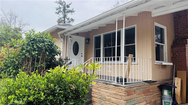 view of exterior entry with brick siding