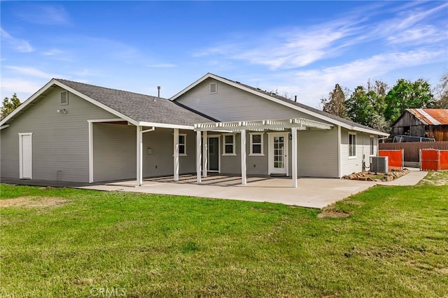 rear view of house with fence, a pergola, central air condition unit, a patio area, and a lawn