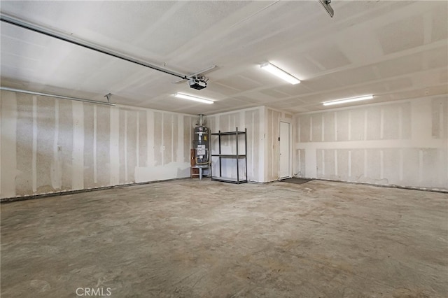 garage featuring strapped water heater and a garage door opener