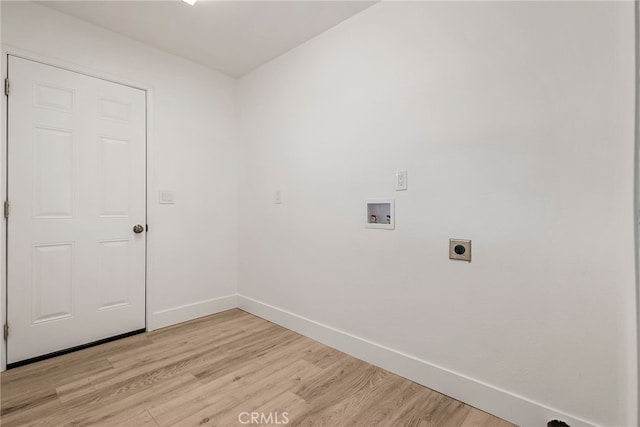 clothes washing area with baseboards, hookup for an electric dryer, laundry area, light wood-style flooring, and washer hookup