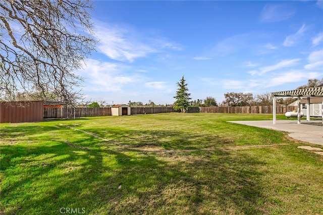 view of yard with a pergola, a fenced backyard, a storage shed, an outdoor structure, and a patio area