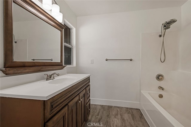 full bath featuring washtub / shower combination, baseboards, and vanity