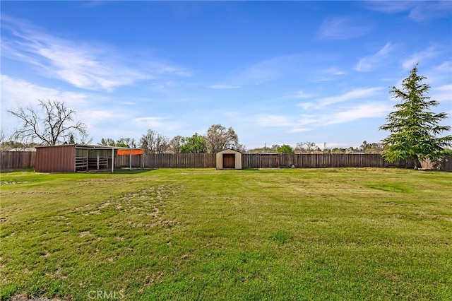 view of yard with an outbuilding and a fenced backyard