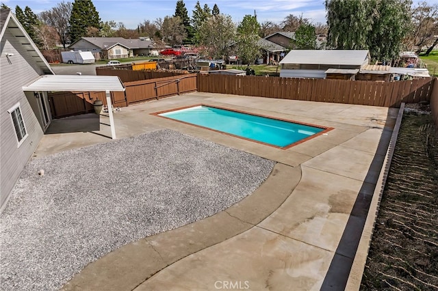 view of swimming pool with a patio area, a fenced in pool, and a fenced backyard