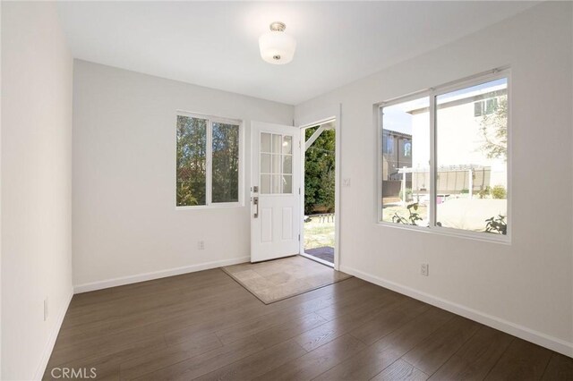 entryway with hardwood / wood-style floors and baseboards