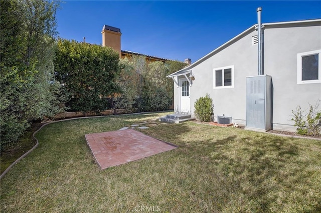 view of yard with central air condition unit and a patio area