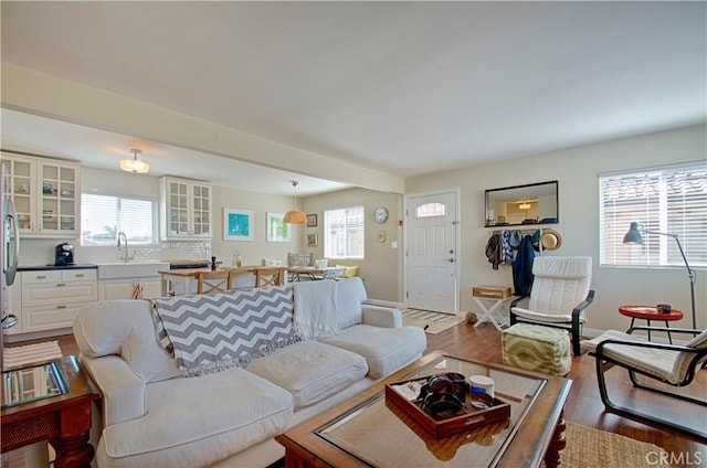 living room with baseboards and wood finished floors