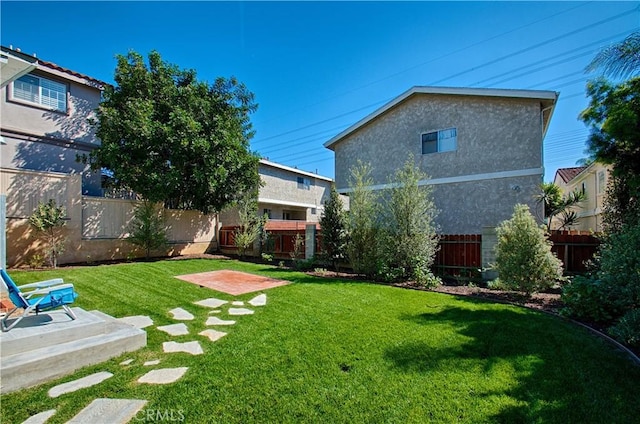 view of yard with a patio area and a fenced backyard