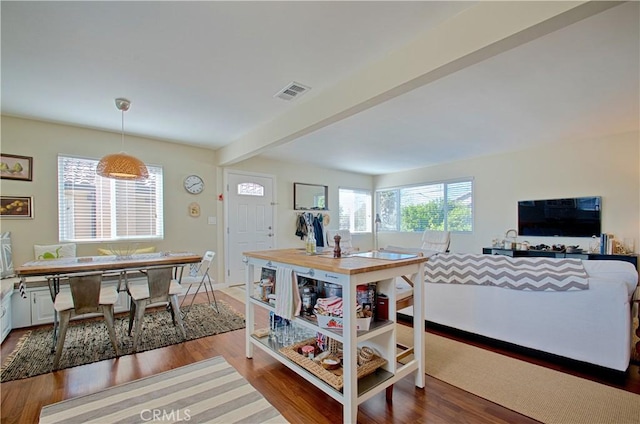 dining area featuring a wealth of natural light, visible vents, and wood finished floors