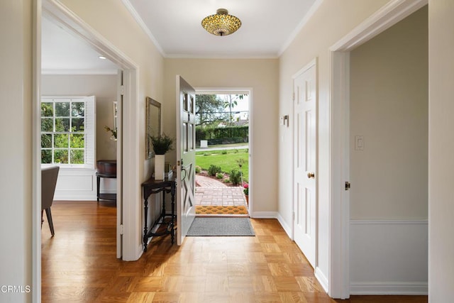 foyer with a wealth of natural light, baseboards, and ornamental molding