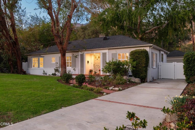 single story home with fence, a front yard, and a gate