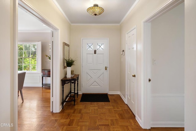 foyer featuring baseboards and ornamental molding