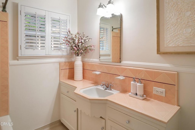 full bath featuring tasteful backsplash, walk in shower, and vanity