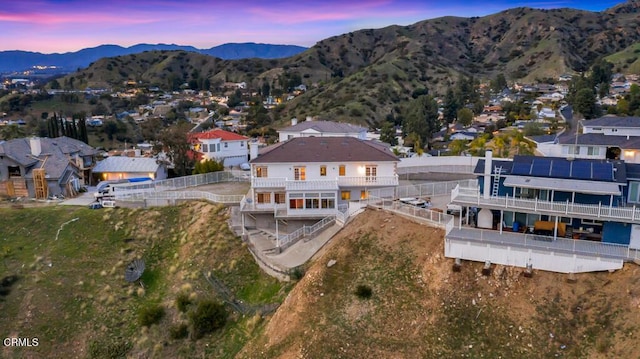 aerial view at dusk featuring a mountain view