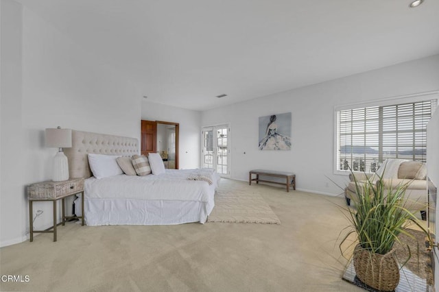 bedroom with visible vents, light colored carpet, french doors, and baseboards