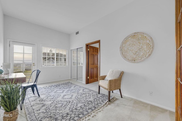 carpeted office space featuring visible vents and baseboards