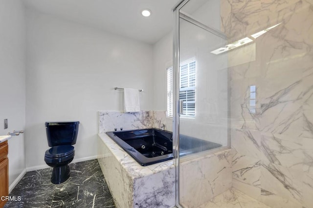 full bathroom featuring baseboards, toilet, a garden tub, marble finish floor, and vanity