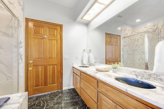 bathroom with a marble finish shower, marble finish floor, a skylight, and a sink