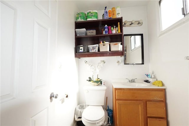 half bathroom with vanity and toilet