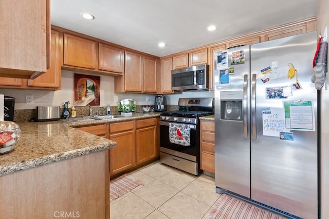 1335 Massachusetts Ave Unit 202, Riverside, CA 92507 - kitchen featuring appliances with stainless steel finishes, light tile patterned floors, recessed lighting, and light stone countertops