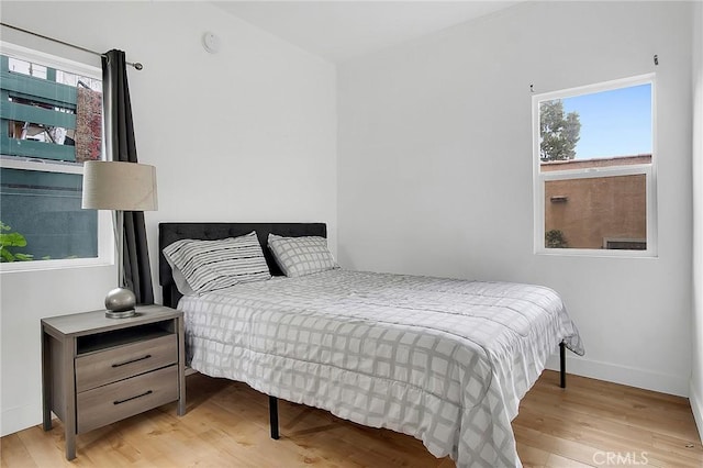 bedroom featuring baseboards and wood finished floors