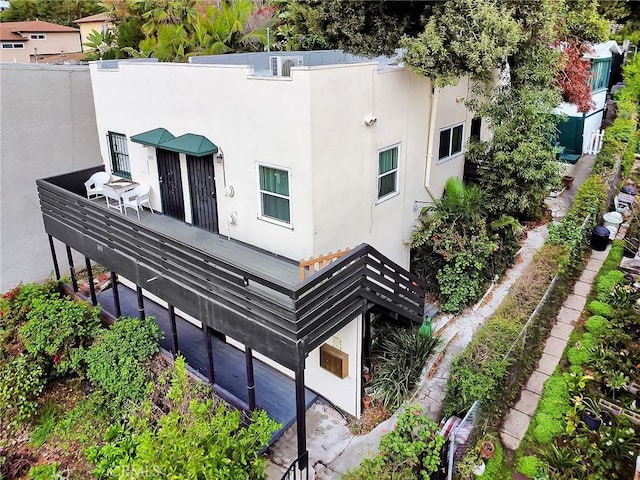rear view of property featuring stucco siding
