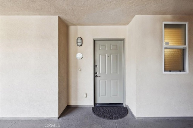 property entrance with stucco siding