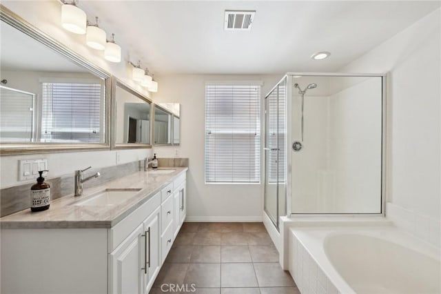 full bath featuring tile patterned flooring, visible vents, a shower stall, and a sink