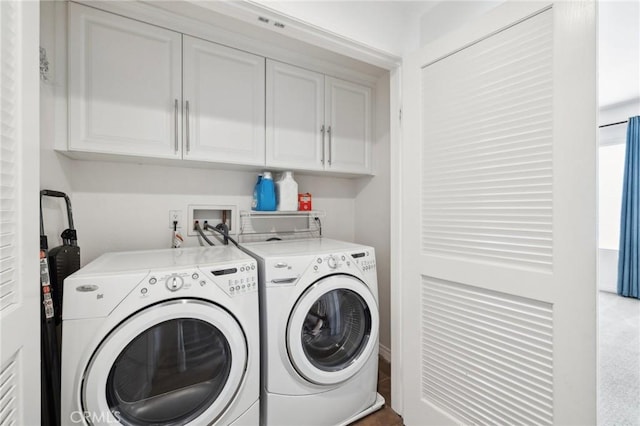 washroom with washer and clothes dryer and cabinet space