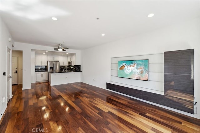 unfurnished living room with dark wood-type flooring, recessed lighting, and ceiling fan