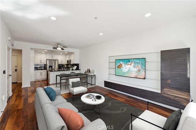 living room featuring recessed lighting, dark wood finished floors, and ceiling fan