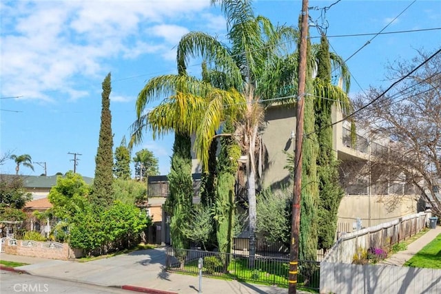 exterior space featuring a fenced front yard and stucco siding