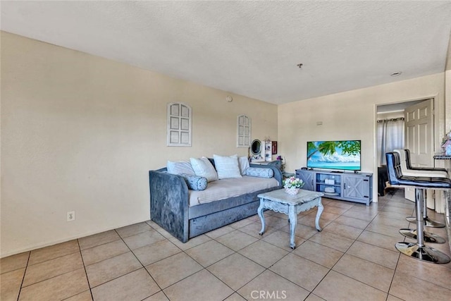 living area with light tile patterned floors and a textured ceiling