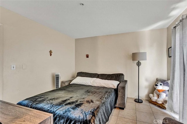 bedroom with light tile patterned flooring and visible vents