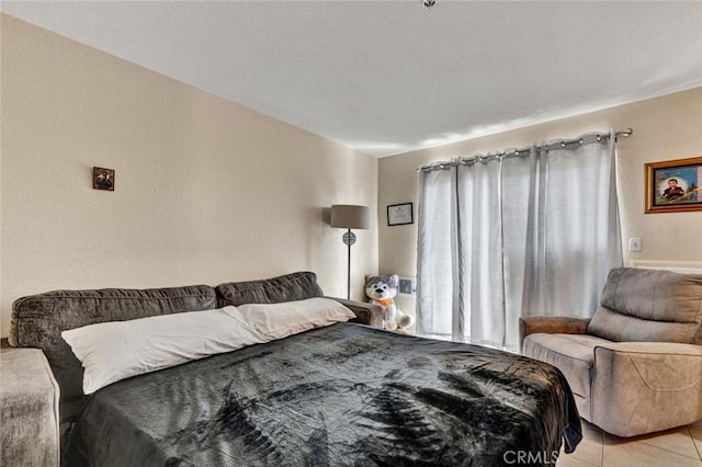 bedroom featuring light tile patterned floors