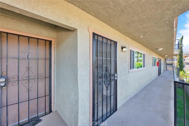 entrance to property featuring stucco siding