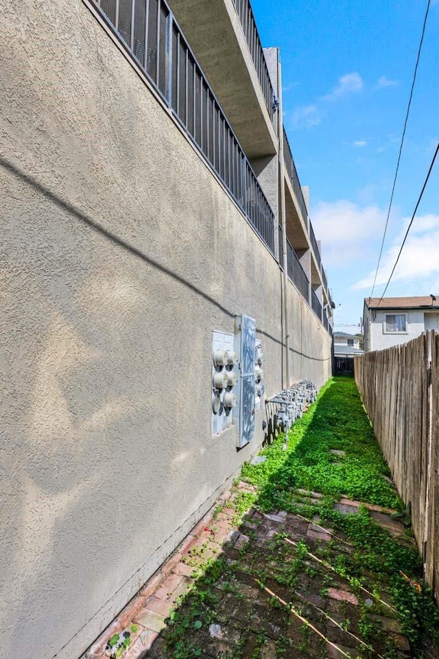 exterior space featuring fence and stucco siding