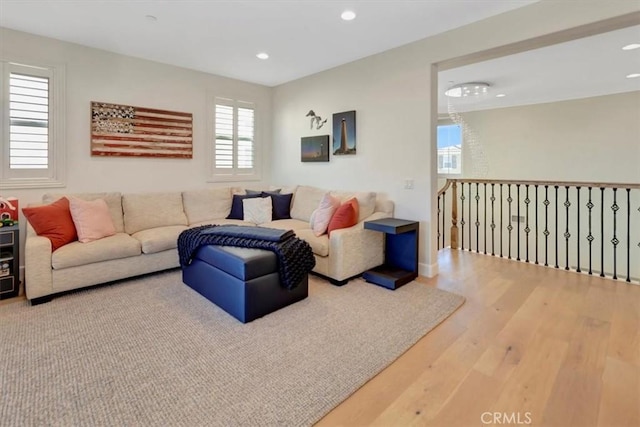 living area with recessed lighting and wood finished floors